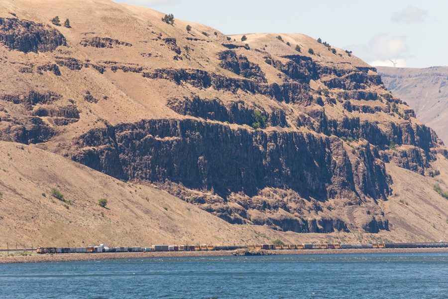 Columnar basalt cliffs along the Columbia River Gorge - note the size of the freight train compared to the cliffs 